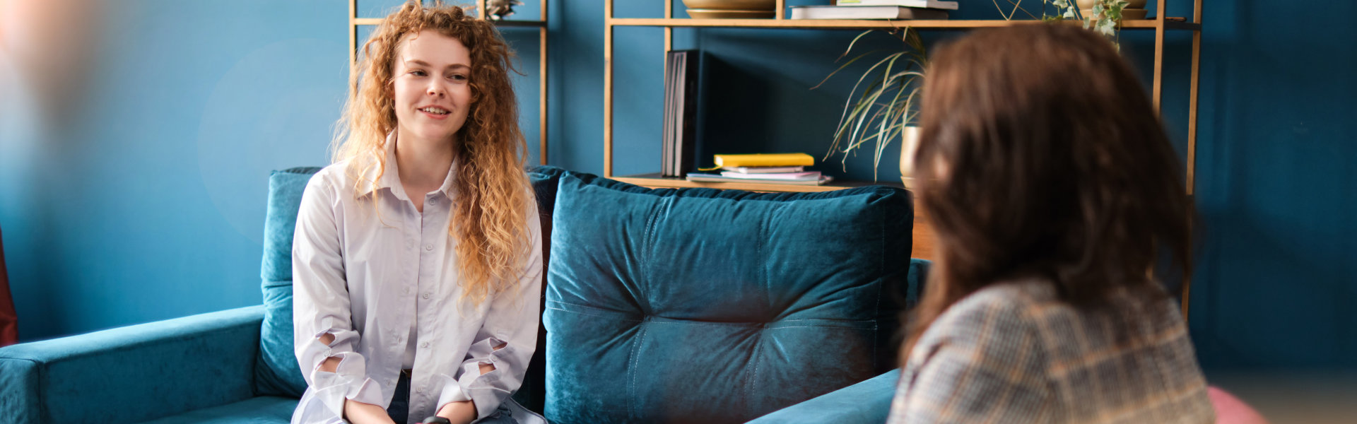 woman smiling while having a conversation